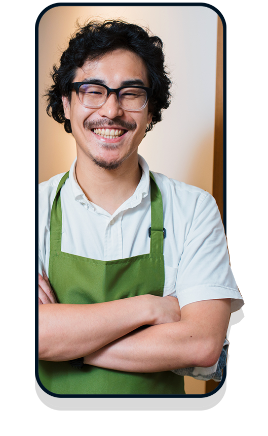 Business owner in white shirt and green apron in mobile frame